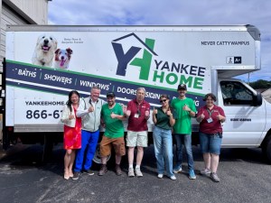Representatives from Yankee Home and Habitat for Humanity MetroWest/Greater Worcester gather during the donation of more than $100,000 in home improvement materials in Worcester, Massachusetts.
