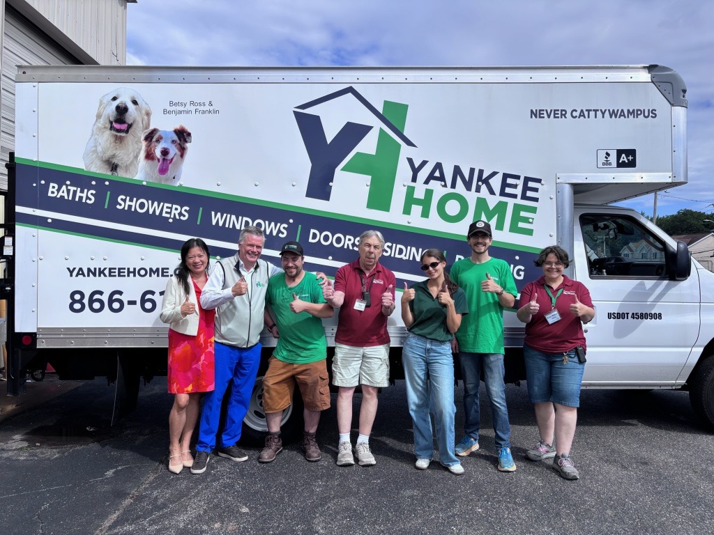 Representatives from Yankee Home and Habitat for Humanity MetroWest/Greater Worcester gather during the donation of more than $100,000 in home improvement materials in Worcester, Massachusetts.